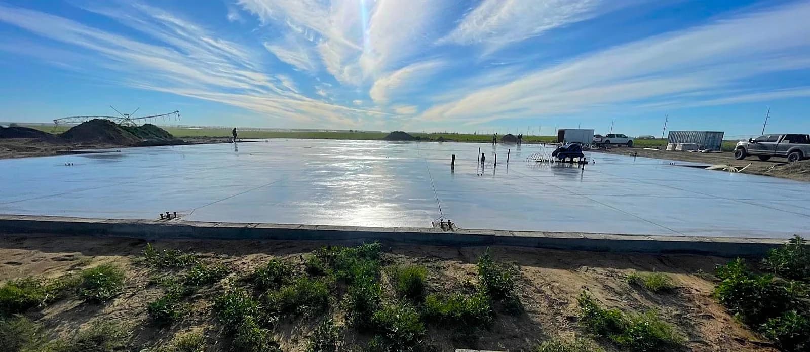 Wide concrete slab pour at an active agricultural worksite
