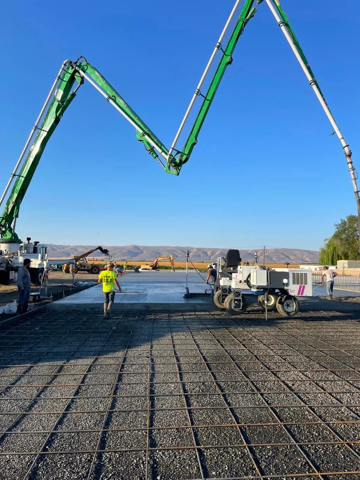 Concrete pump truck placing a pour over a reinforced slab